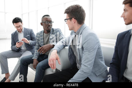 group of employees sitting in the office lobby. Stock Photo