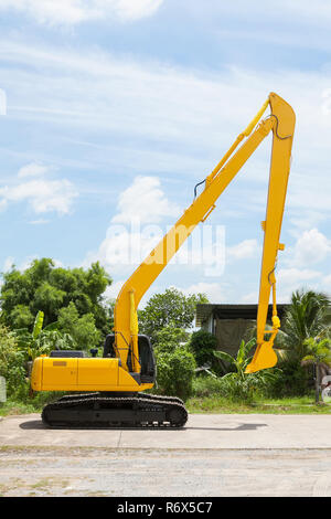 Hydraulic Yellow Excavator side view on outdoor location. Stock Photo