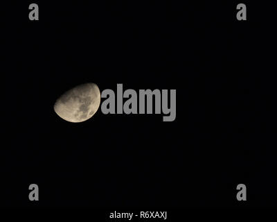 Gibbous Moon Isolated Against Black Night Sky with space for text or copy. Stock Photo