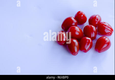 Red small cherry tomatoes in group on white background Stock Photo