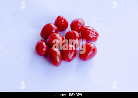 Red small cherry tomatoes in group on white background Stock Photo