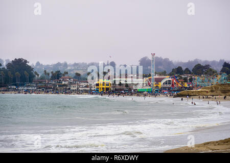 July 1, 2018 Santa Cruz / CA / USA - The Crowds having fun on the beach and at the Santa Cruz boardwalk on a foggy day; Stock Photo