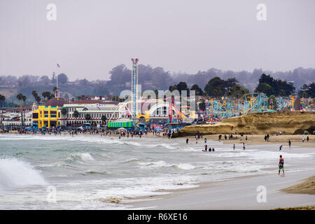 July 1, 2018 Santa Cruz / CA / USA - The Crowds having fun on the beach and at the Santa Cruz boardwalk on a foggy day; Stock Photo