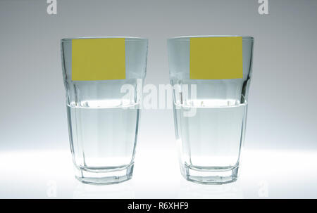 Two glasses one empty, one full of clean water Stock Photo - Alamy