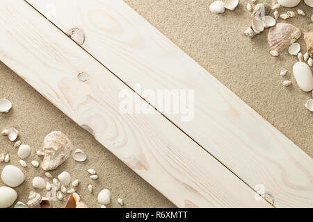 sandy beach background with shells and stones Stock Photo