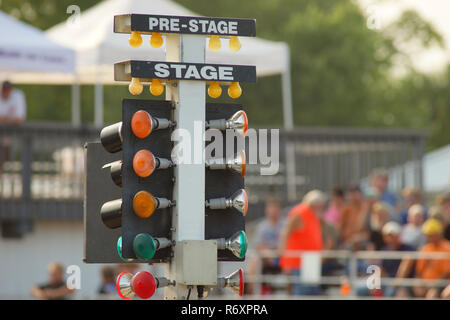 Red green and yellow lights go down the tree to indicate the start of the race Stock Photo