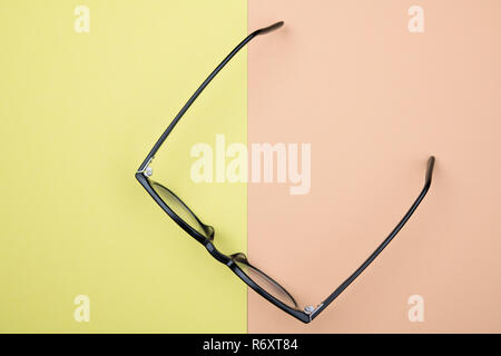 black glasses on yellow and orange ground Stock Photo