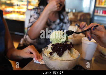 A yummy bowl of Korean Bingsu can be made from all kinds of sweets topped over shaved ice. Stock Photo