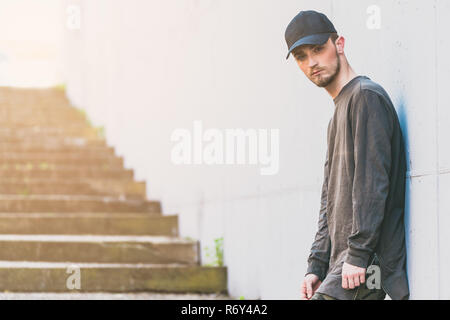 portrait of a young bearded man wit cap looking at camera with copy space for text Stock Photo