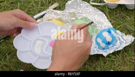 Painting on chicken egg for Easter holiday Stock Photo
