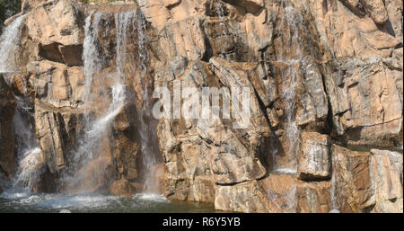 Waterfall over the rock wall Stock Photo