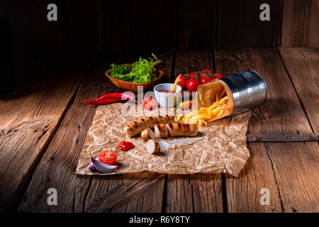 rustic bratwurst with pommes and hot ketchup Stock Photo