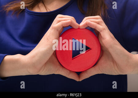 Close-up Of A Woman's Hand Holding Play Icon Stock Photo