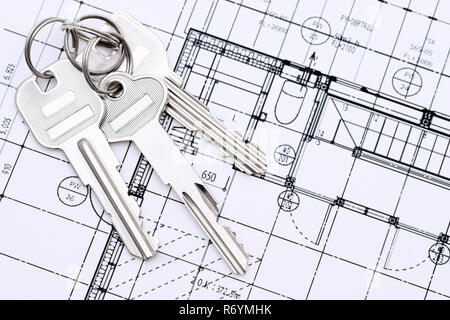 Keys on blueprint, creating new architectural project on table Stock Photo