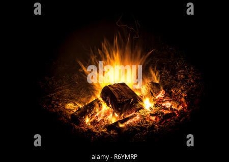 bright burning fire with embers in front of black background Stock Photo