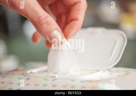 Hand picked a wet wipes in package box, Wet wipes in a woman's hand Stock Photo