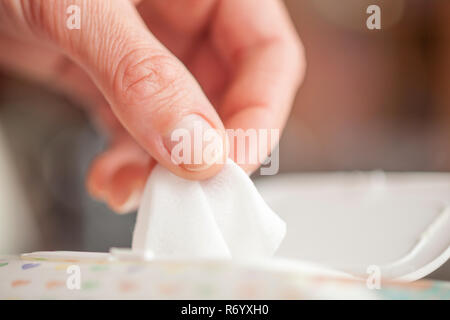 Hand picked a wet wipes in package box, Wet wipes in a woman's hand Stock Photo