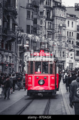 The historic red tram on Istiklal Caddesi, one of the busiest shopping street in Taksim Istanbul, Turkey Stock Photo