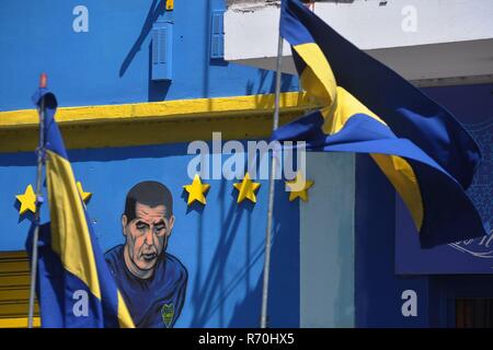 December 7, 2018 - Buenos Aires, Buenos Aires, Argentina - A graffiti of Boca Juniors' star player Juan Roman Riquelme in a wall painted with the club's colours in front of the ''Bombonera'' (Spanish for chocolate box, a nickname the stadium got from its particular shape), the club's football stadium, a tourist attraction and a place of pilgrimage for football fans from all over the world. Founded in 1905 by five Italian friends, Boca Juniors is the most successful football team in Argentina, the only one that since being promoted to the first division in 1913 never descended category, and by  Stock Photo
