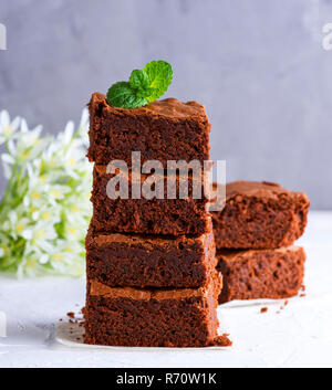 a pile of square slices of baked brownie pie Stock Photo
