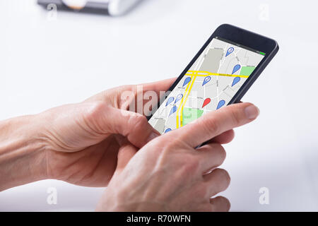 Person Using GPS Navigation Map On Mobile Phone Stock Photo