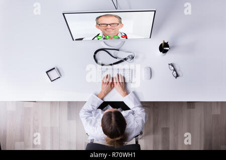 Doctor Video Conferencing With Male Colleague Stock Photo