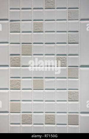 Texture of small squares of mosaic in white and beige ceramic tiles. Stock Photo