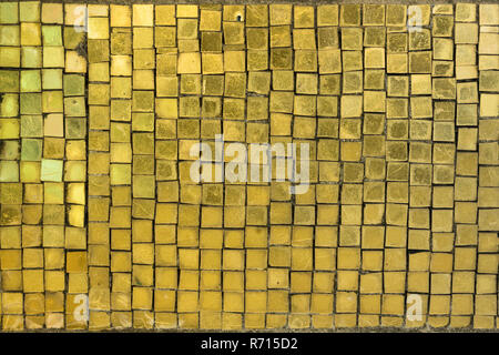 Texture of small squares of mosaic in golden yellow ceramic tiles. Stock Photo