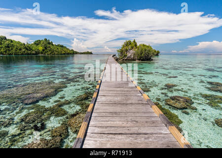 The connecting bridge to the main island from the sea gypsy village in the Togian Islands in Sulawesi, Indonesia Stock Photo