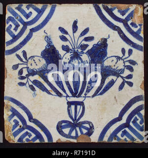 White tile with blue fruit bowl on stand, apples and grapes; corner pattern meander angle, wall tile tile material ceramics pottery glaze, baked 2x glazed painted Red shard square three and four nail holes. AVIa chinoiserie Stock Photo