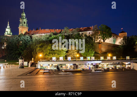 Wawel Castle by night in Krakow city, Poland, view from the Napoleon's great army Square, illuminated the fortress and stores Stock Photo