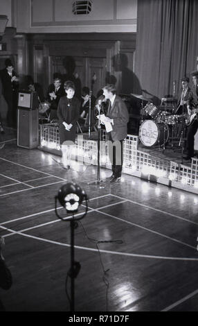 1960s, music audition, a young woman having an audition as a singer, with The Devils pop group, England, UK. Stock Photo