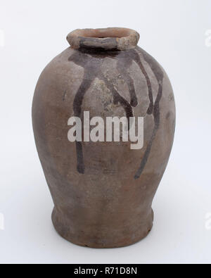 Pottery pot on stand, baluster shape, used in the sugar industry, sugar bowl pot holder soil find ceramic earthenware glaze lead glaze, hand turned glazed baked Pottery pot on stand. Baluster shape with round shoulder and narrow neck opening. Thick and round neck edge Smooth finished Red shard internal glazed whimsical glaze tears over the outside. Here sugar cones were made archeology indigenous earthenware sugar confectionery sugar industry Stock Photo