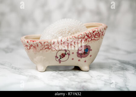 Decorative  Ceramic Mini Claw Foot Bathtub Soap Dish with Bath Sponge Stock Photo
