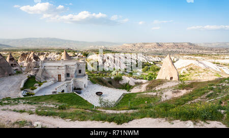 modern and ancient rock-cut buildings in Uchisar Stock Photo