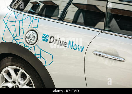 Germany, Berlin, September 05, 2018: Close-up on a company sign on a BMW electric car for the rental from a company called DriveNow. Car rental takes place through a mobile application. Stock Photo
