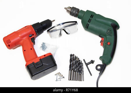Drill and screwdriver on a white background Tools on a white background. Isolated objects. Items for repair and collection of furniture. Stock Photo