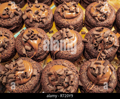 delicious chocolate muffins filled with hazelnut cream and covered with chocolate chips Stock Photo