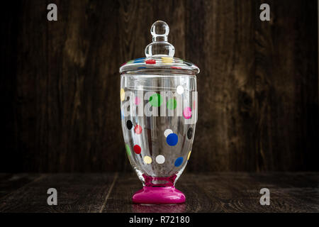 Colorful Empty Glass Jar on Wooden Background Stock Photo