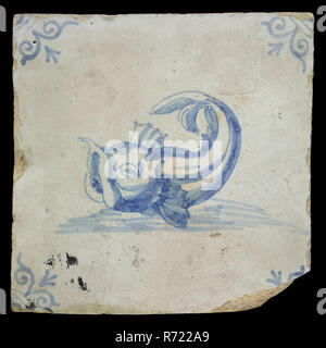 IB, Animal tile with fish, blue decor on white ground, corner filler ox head, marked, wall tile tile image ceramics pottery glaze tin glaze, in shape made baked glazed painted baked Wall tile with blue decor on white background. Animal tile with big fish on the water. The fish has snapped beak large fins behind the gills the tail curled up Angle filler ox head. brown-yellow shard Scraped earthenware. Slightly slanted sides. Marked at the back In blue paint on the back marked: IB in ornate letters Rotterdam City triangle Sand street indigenous pottery Originating from the Zandstraat Rotterdam a Stock Photo