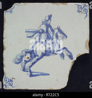 IK, Figure tile, rider on rearing horse, blue decor on white ground, corner filling: ox head, marked, wall tile tile sculpture ceramics pottery glaze tin glaze, in form made baked glazed painted baked Wall tile with blue decor on white fond. Figure tile with rider on scaffolding horse as the central idea The decor is set up with thin purple line Orange yellow shard. Scraped earthenware Slightly slanted sides. Marked at the back In blue paint on the back: IK Rotterdam City Triangle Zandstraat Originating from the Zandstraat Rotterdam area. Stock Photo