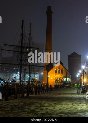 Liverpool, England, UK - November 1, 2015: The Pump House of Liverpool's regenerated docks is lit on a foggy night. Stock Photo