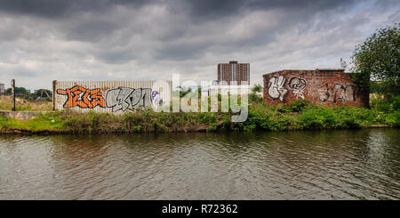 Manchester, England, UK - May 21, 2011: Derelict wasteland awaits redevelopment alongside the Bridgewater Canal at Pomona Strand in Manchester, with h Stock Photo