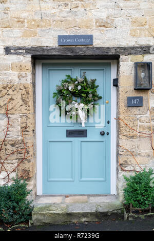 Christmas wreath on a cottage door in Burford. Cotswolds, Oxfordshire, England