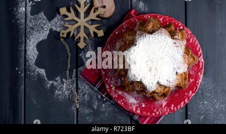 Italian Christmas cupcake with powdered sugar. Traditional festive pastries in the form of stars and decor on a dark wooden background. Top view. Free Stock Photo