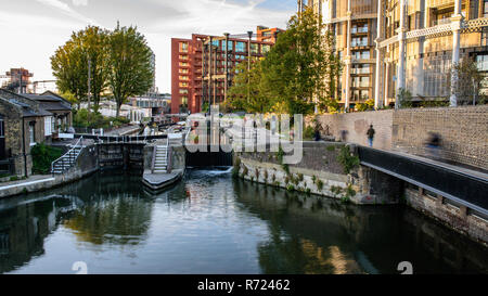 London, England, UK - September 24, 2018: Pedestrians and cyclists travel along the Regent's Canal towpath at St Pancras Lock, beside Gasholders Park  Stock Photo