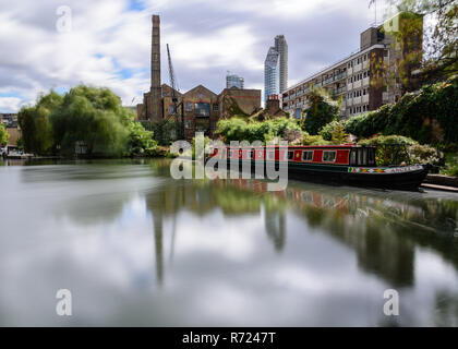 London, England, UK - September 21, 2018: Trees are blown in the wind at City Road Lock on the Regent's Canal, beside a traditional narrowboat and ind Stock Photo