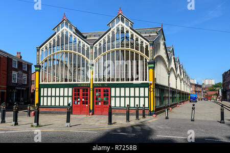 Stockport, England, UK - July 2, 2018: Sunshine illuminates the traditional Victorian Market Hall and cobbled Market Place of Stockport in Greater Man Stock Photo