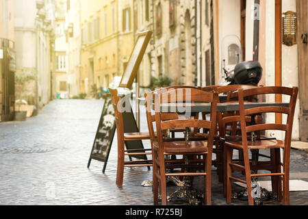 Empty dining table with chairs is standing in a empty stree Stock Photo