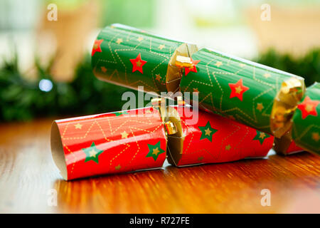 Red and green christmas crackers with stars closeup, with a bokeh background Stock Photo
